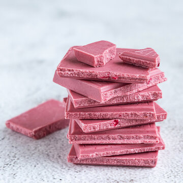 Pink or ruby chocolate, trendy dessert on grey background