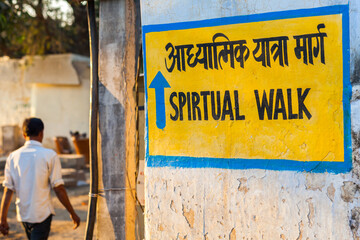 Painted wall mural with sign indicating the direction of a spiritual walk