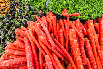 Carrots, eggplants and green peppers at an Indian market