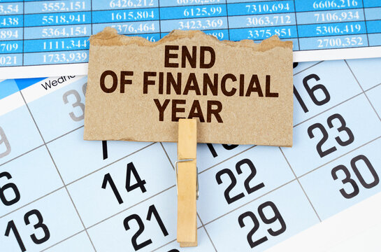 On the calendar and reporting documents is a cardboard plate with the inscription - END OF FINANCIAL YEAR