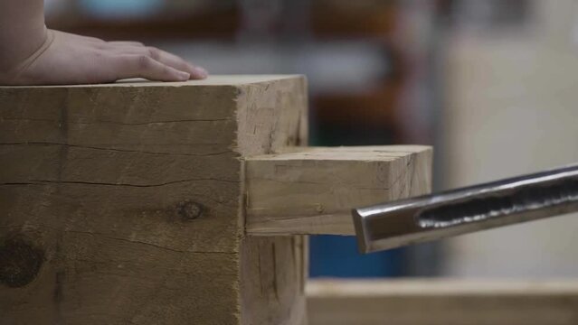 Chiseling at wooden post closeup