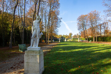 Old statue and  view of the garden of the national domain Saint-Cloud with a fantastic autumn   park in Paris
