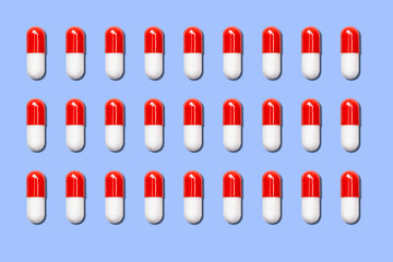 lot of red and white medical capsules on a blue background.