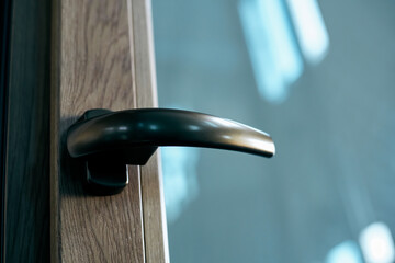 handle with a lock on the window frame.