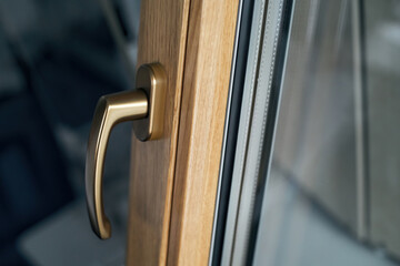 stylish handle on the window frame in gold color. - 534342580