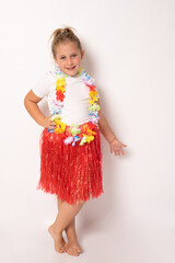 Full length portrait of little child girl in hawaiian costume standing isolated white background