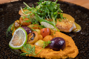 Fototapeta na wymiar typical salvadorean food and drinks, sea bass on carrot purée
