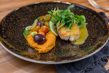 typical salvadorean food and drinks, sea bass on carrot purée