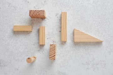 Top view of different Wooden set pieces on a white surface, kids education