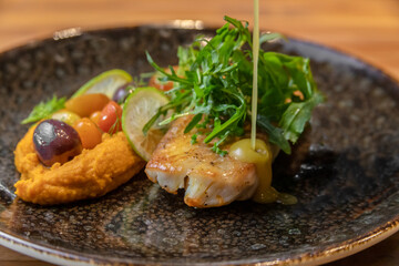 typical salvadorean food and drinks, sea bass on carrot purée