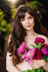 Naklejka premium an beautiful woman with long hair and bare shoulders and a bouquet of peonies