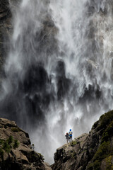 Male and female hikers admiring Yosemite Falls, Yosemite National Park, California