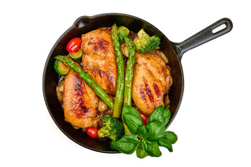 Roasted chicken breasts with vegetables in frying pan. Healthy food, isolated on white background....