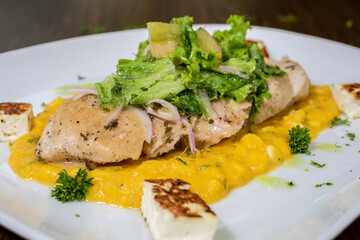 Typical colombian food and drinks, grilled chicken over carrot purée
