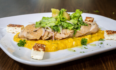 Typical colombian food and drinks, grilled chicken over carrot purée