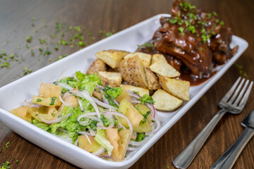Typical colombian food and drinks, bbq ribs with helmet potatoes