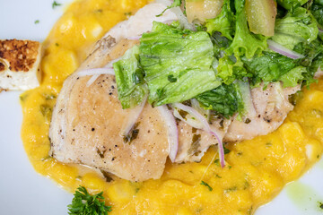 Typical colombian food and drinks, grilled chicken over carrot purée