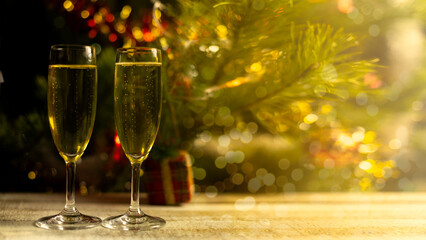 HAPPY NEW YEAR 2023 - Festive background banner Golden yellow lights and two champagne classes toasting on black night texture