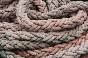Fototapeta na wymiar Rolled up old nautical marine rope