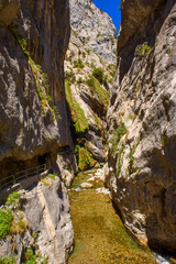 Cares river gorge route. Hiking trail in Picos de Europa National Park, Spain. Mountain path between impressive cliffs