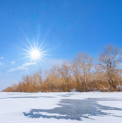 frozen river at the cold sunny day, winter outdoor scene