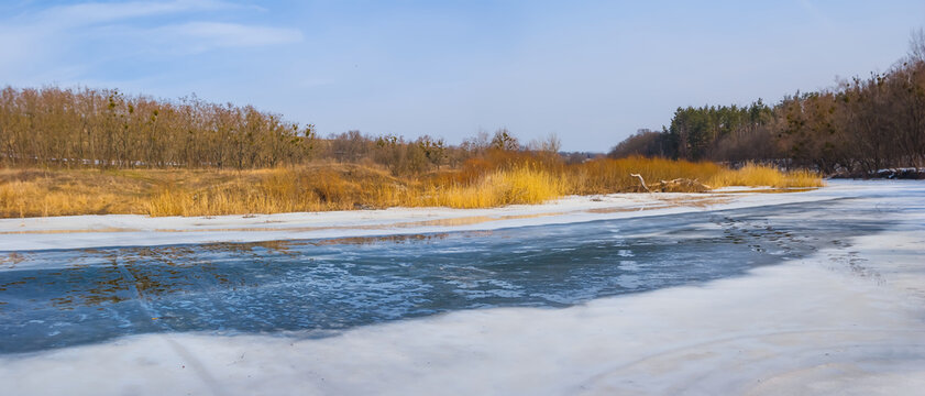 small melting river at bright winter day, winter seasonal outdoor landscape