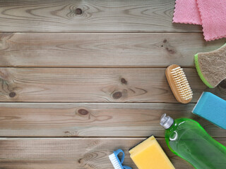 Accessories for cleaning at right on wooden light background. Cleaning service concept. Flatlay. Mockup for advertisement with copy space. Top view. Copy space