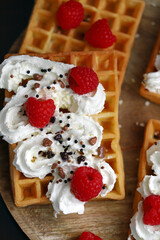 Fresh Viennese waffles with cream and raspberries. Summer dessert with berries.