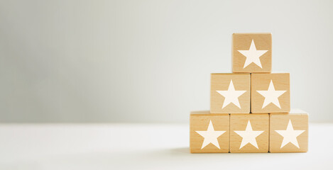 five star goal,Satisfaction survey,Customer service experience,Customer service evaluation and classification,business concept.,white five star icon on Wooden cube stack with copyspace.