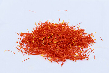 Fototapeta premium A pile of saffron stamens on a white background. Drying spices, use in cooking.