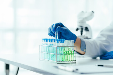 Medical research laboratory asian people male scientist working and analysing liquid biochemicals...