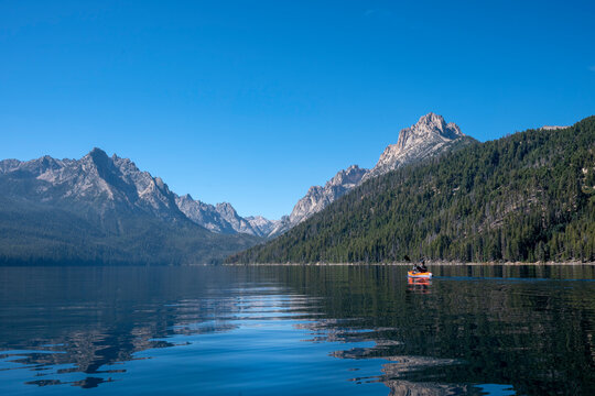 USA, Idaho, Redfish Lake. Sawtooth Mountains. Man kayaking. (MR)