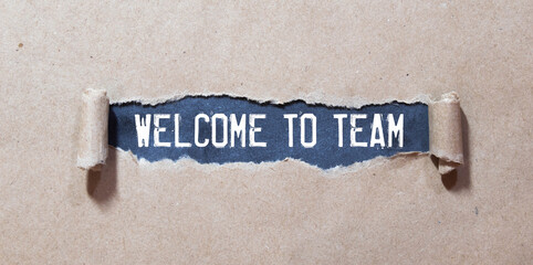 WELCOME TO TEAM text concept write on notebook with office tools on wooden background
