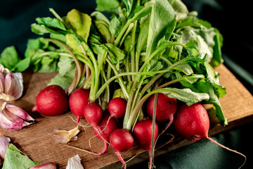 a bunch of red radishes on a wooden table.