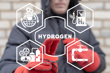 Industry worker using virtual touchscreen presses word: HYDROGEN. Concept of hydrogen innovative production. H2 Fuel Modern Manufacturing.