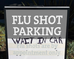 Parking sign posted at a clinic for free flu shots