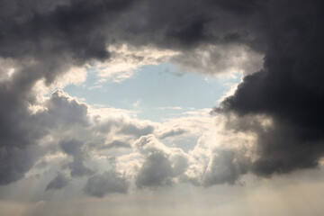 Fototapeta na wymiar Beautiful dramatic cloudscape with fluffy clouds over clear blue sky