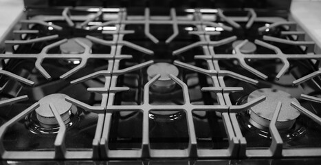 Kitchen surface in stainless steel with cast iron grill. View from above. Stove hob cooking kitchen cooker metal burner