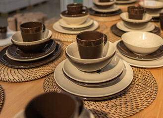 Empty plates and cups on wooden table. Ceramic tableware.