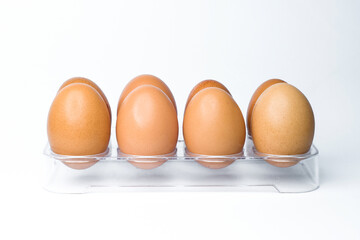 eight chicken eggs in a pocket on white background