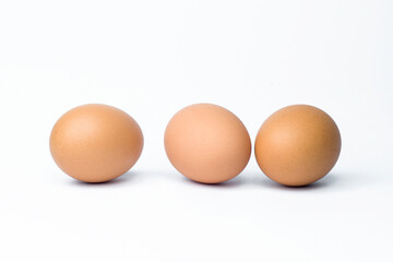 three chicken eggs on white background