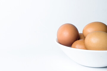 negative space, chicken eggs in a white bowl on white background