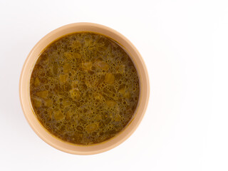 Soup in a plate on a white background. Space for text