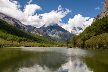 Fototapeta na wymiar Beautiful Summer scene in Daocheng Yading National park, Sichuan, China, lake, sky reflection, copy space for text, background, wallpaper