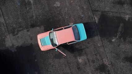 Top view of empty abandoned car open doors on asphalt empty parking lot, reported stolen, bandit district. Thieves stole car, broke, abandoned it on deserted outskirts of city. Apocalypse, doomsday, 