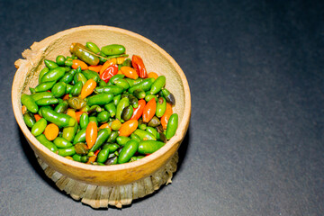 chiltepin chili presented in a traditional jicaro container