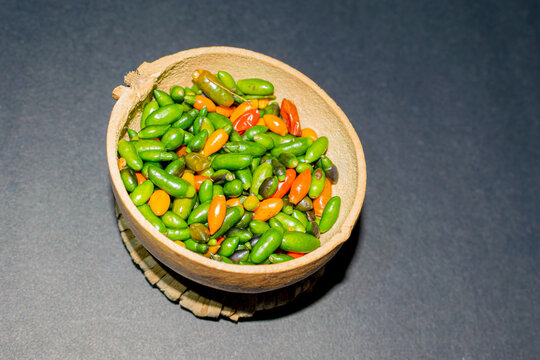 chiltepin chili presented in a traditional jicaro container