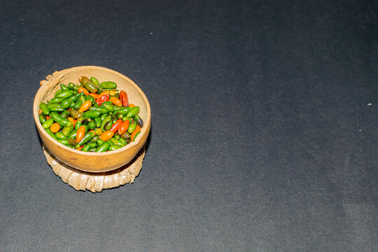 chiltepin chili presented in a traditional jicaro container