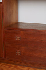 Product Photography detail of a Mid-Century Modern Teak Wall Unit shelf, furniture interior design concept.