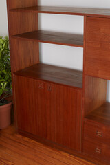 Product Photography detail of a Mid-Century Modern Teak Wall Unit shelf, furniture interior design concept.